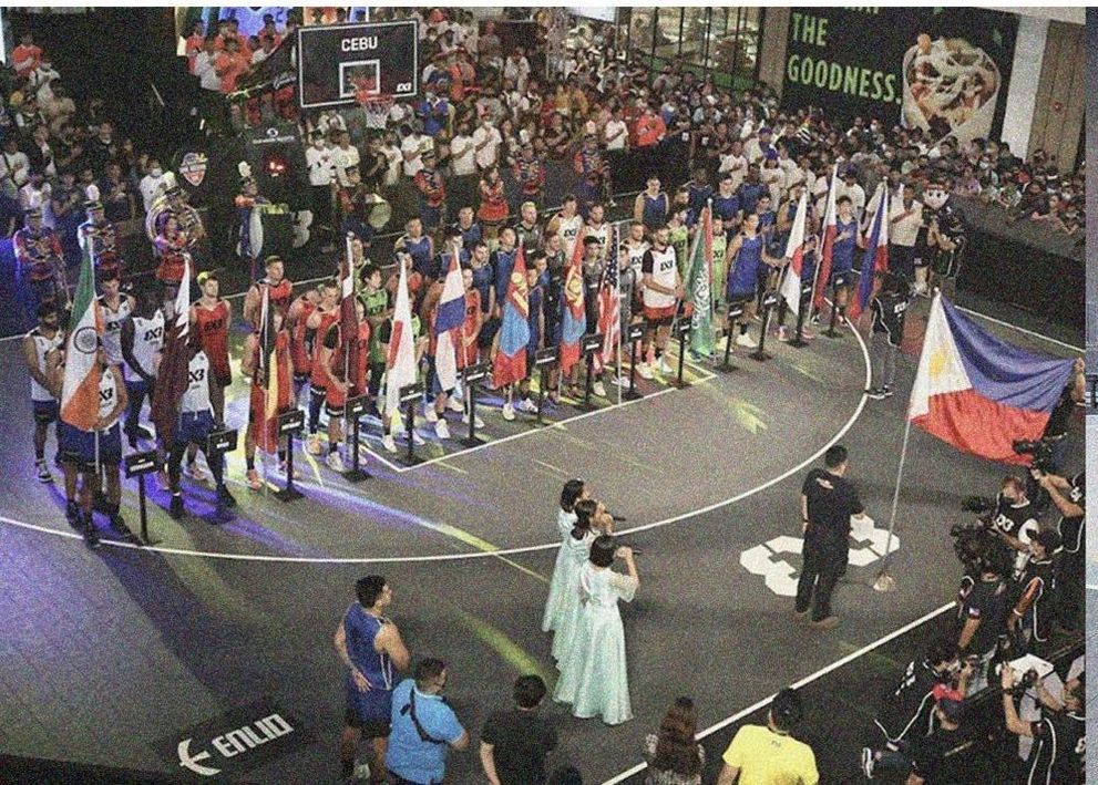 A FIBA 3x3 event court surrounded by a packed crowd and national flags