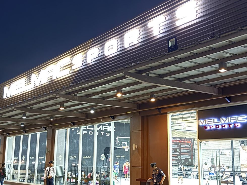 The lit Melmac Sports building at Vista Mall Imus at night