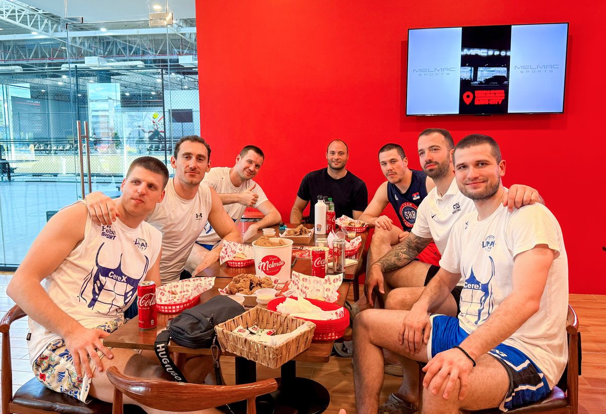 A team gathered around a table of food at Planet Melmac Imus