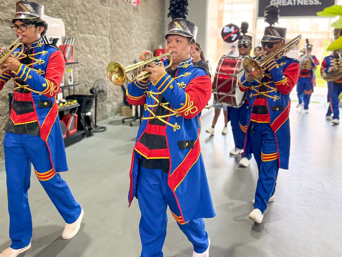 A marching band playing inside Melmac Sports Imus