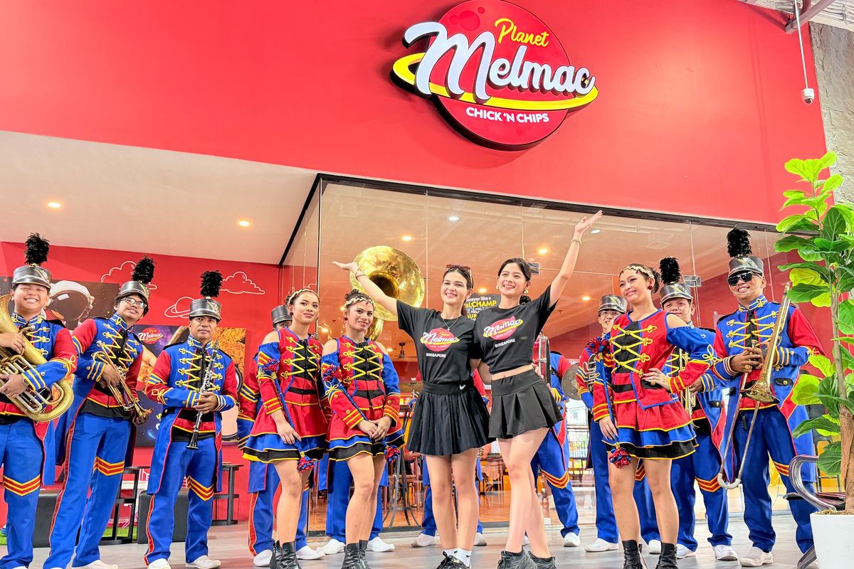 Performers and the marching band lined up in front of Planet Melmac Imus
