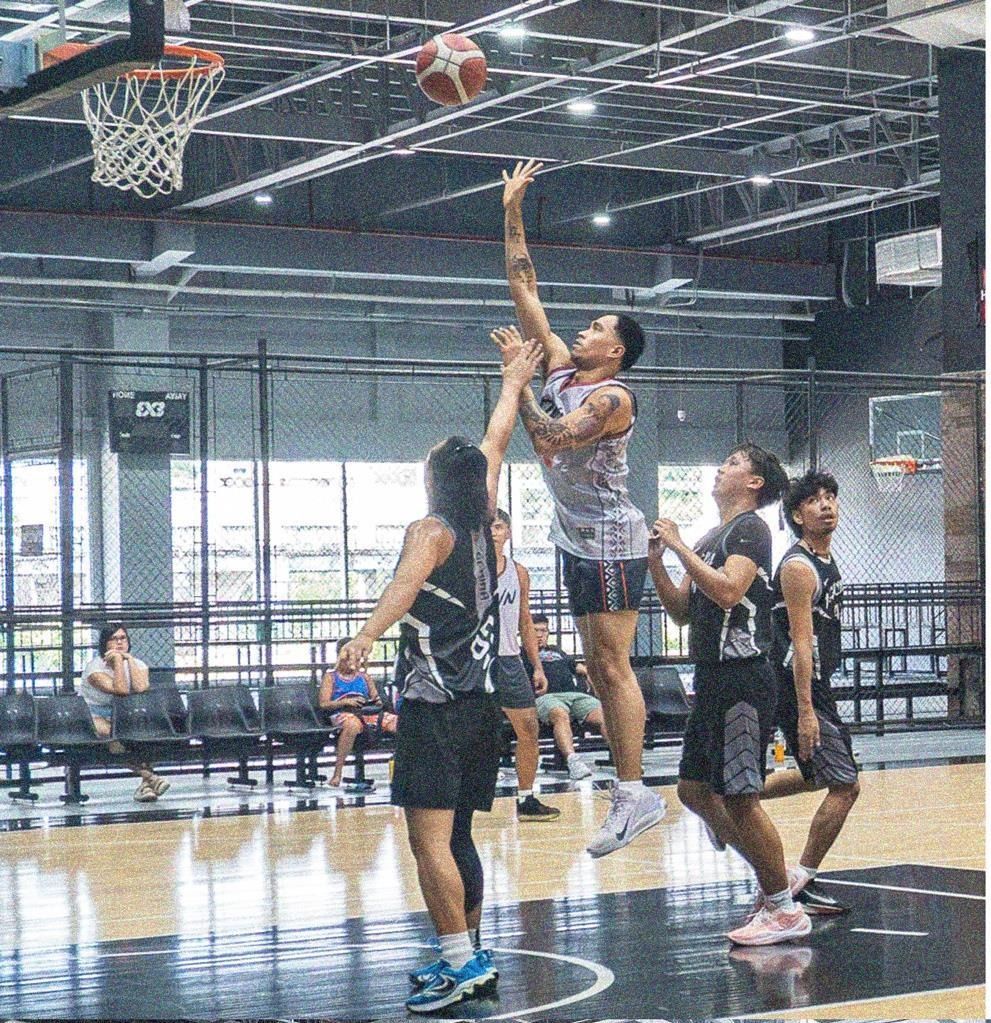 Players competing on the court at a Melmac Sports basketball tournament