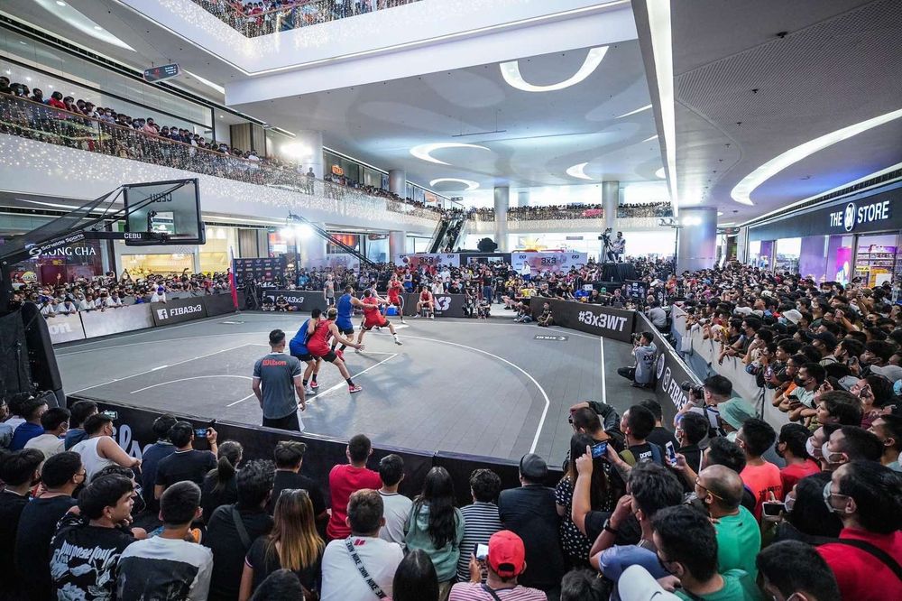 A packed mall atrium surrounding the show court at a FIBA 3x3 World Tour event
