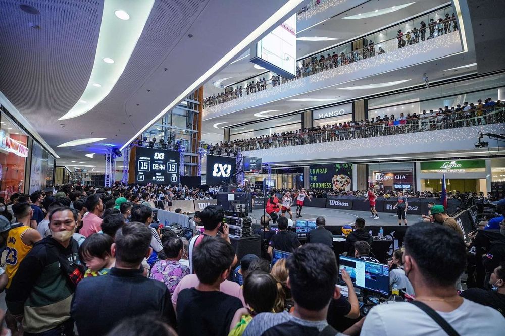 Crowds filling every balcony above a 3x3 show court