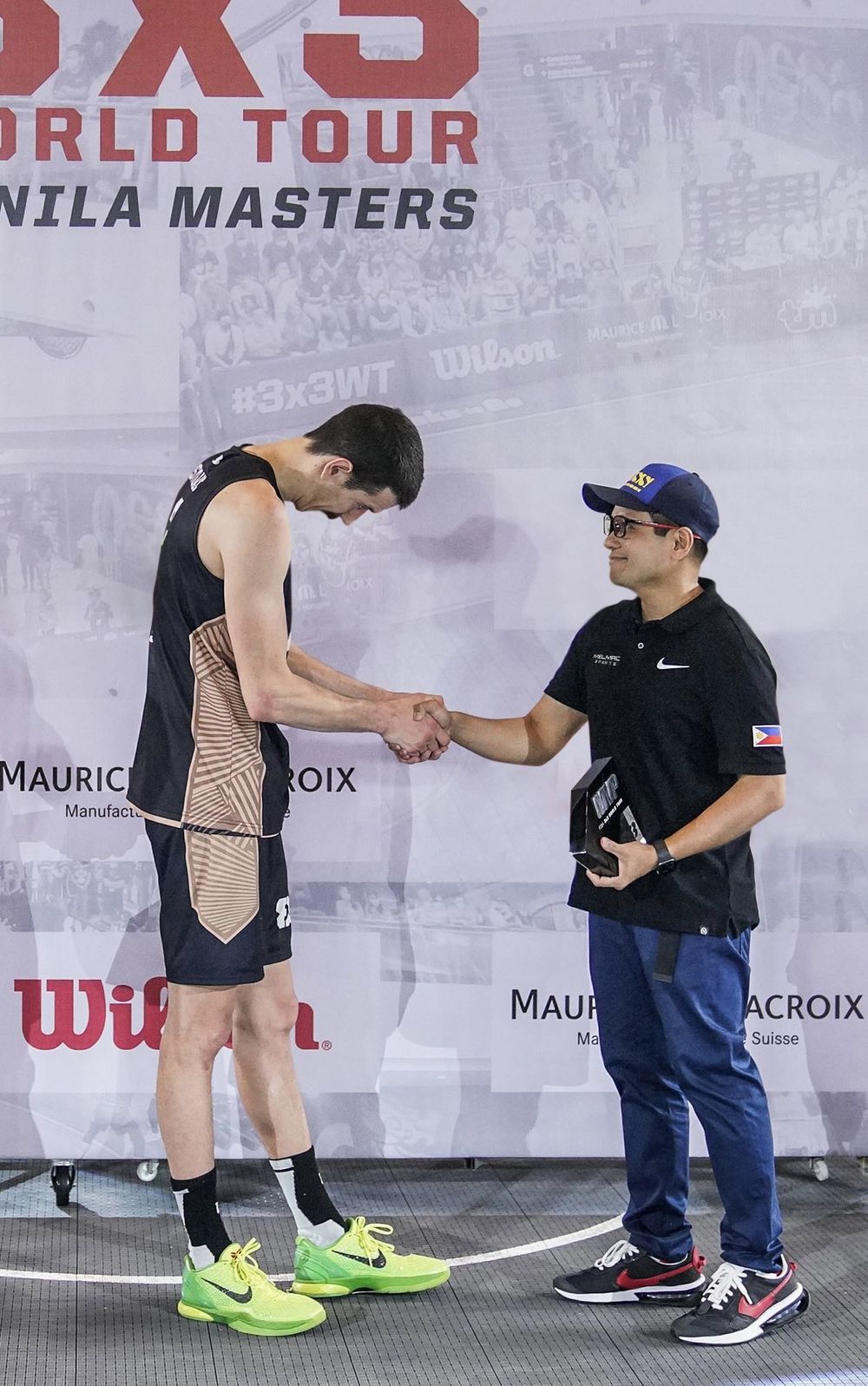 A player shaking hands at the 3x3 World Tour Manila Masters backdrop